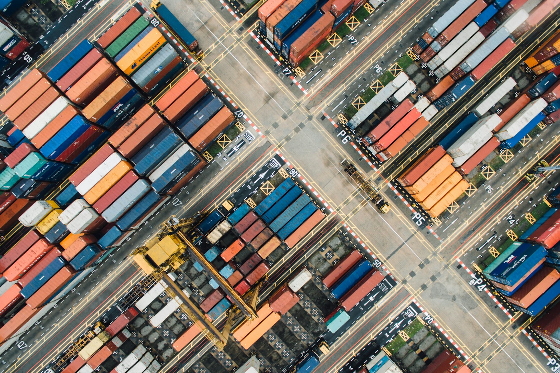 Aerial view of a container yard with stacked shipping containers